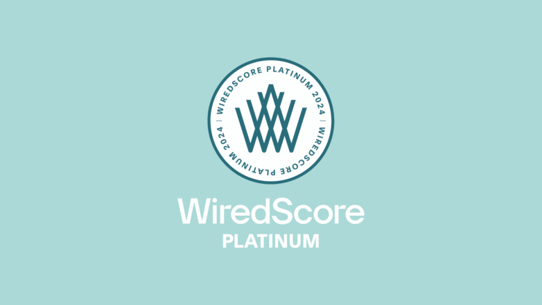 WiredScore Platinum badge next to smart tech setup in modern studio