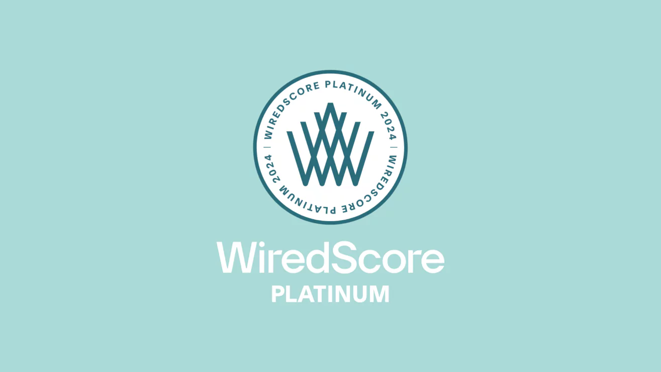 WiredScore Platinum badge next to smart tech setup in modern studio